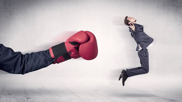 Huge Boxing Gloves punches businessman concept - Zdjęcie, obraz