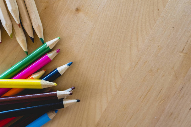 Colored pencils on a table with space for text. - 写真・画像