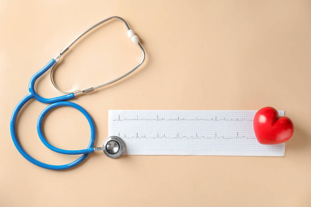 Медицинский стетоскоп, красное сердце и кардиограмма на светлом фоне
 - Фото, изображение