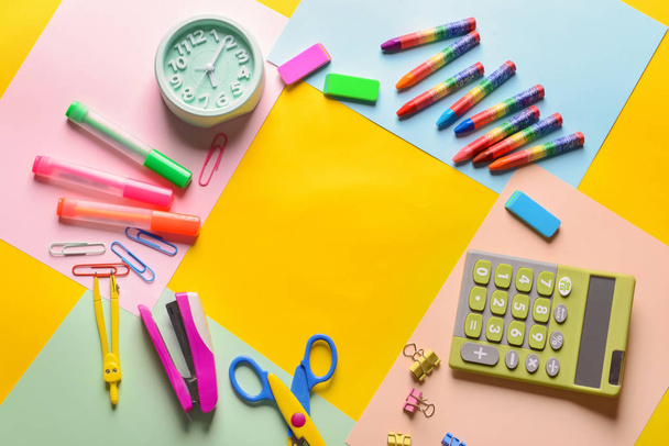 Set of school stationery with calculator and alarm clock on color background - 写真・画像