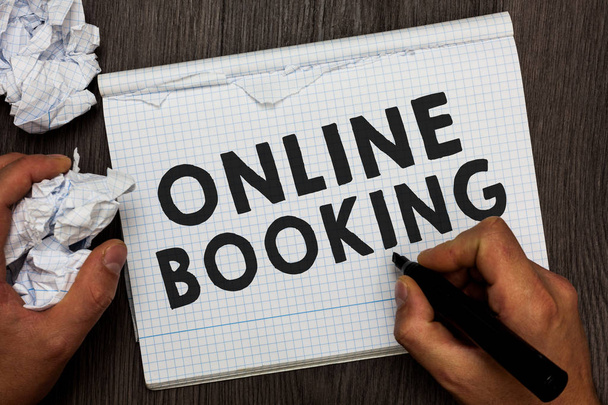 Writing note showing Online Booking. Business photo showcasing Reservation through internet Hotel accommodation Plane ticket Man holding marker notebook crumpled papers several tries made. - Photo, Image