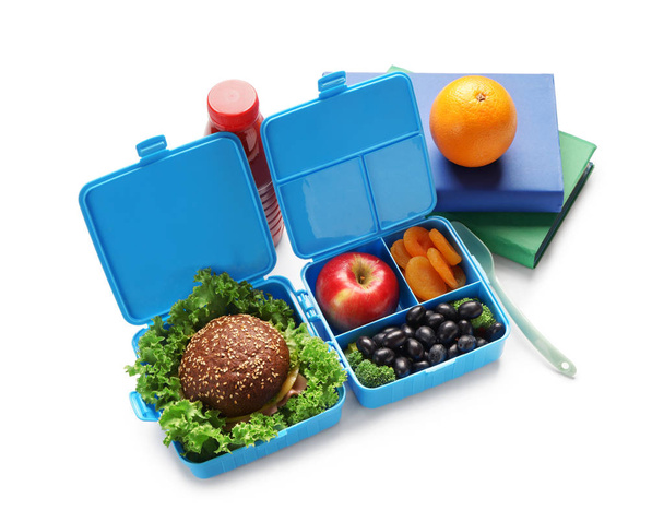 Food for schoolchild in lunch boxes on white background - Photo, Image