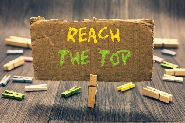 Writing note showing Reach The Top. Business photo showcasing Get Ahead Succeed Prosper Thrive for the Win Victory Clothespin holding paperboard important communicating message ideas. - Photo, Image