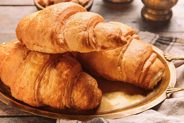 Metal tray with tasty croissants on table - Photo, Image