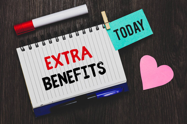 Writing note showing Extra Benefits. Business photo showcasing Additional compensation Bonus Subsidies Incentives Allowances Open notebook pin holding reminder marker heart wooden background. - Photo, Image