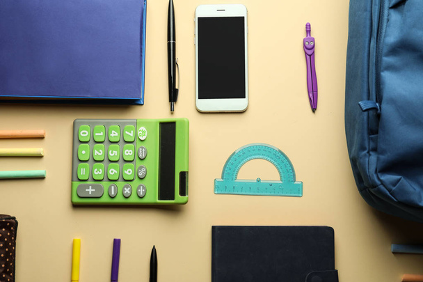 Composition with different school stationery and phone on light background - Foto, Bild