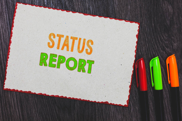 Text sign showing Status Report. Conceptual photo Update Summary of situations as of a period of time White paper red borders colorful markers wooden background expressing ideas. - Photo, Image