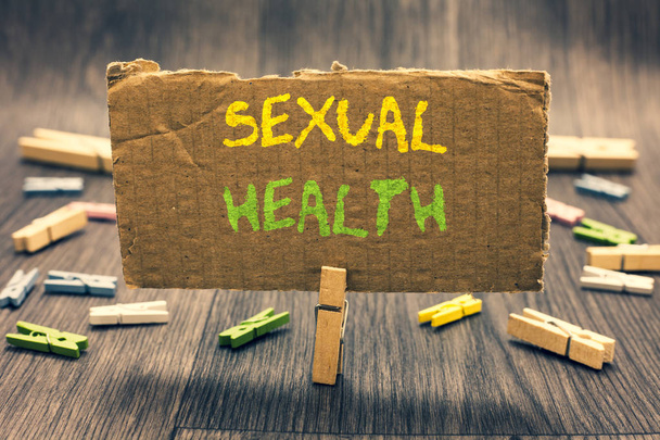 Writing note showing Sexual Health. Business photo showcasing Healthier body Satisfying Sexual life Positive relationships Clothespin holding paperboard important communicating message ideas. - Foto, imagen