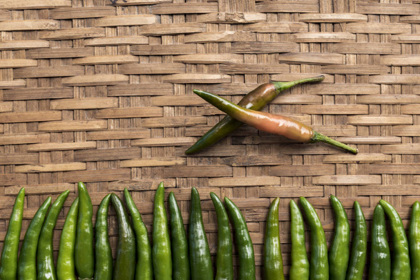 Fresh green chilli paste on bamboo background. Space left to place text. Thai spices.  Close up top view. - Photo, Image