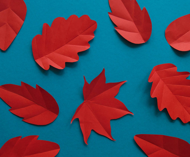 Leaves of paper autumn red leaf fall. Blue background.Handmade origami. - Φωτογραφία, εικόνα