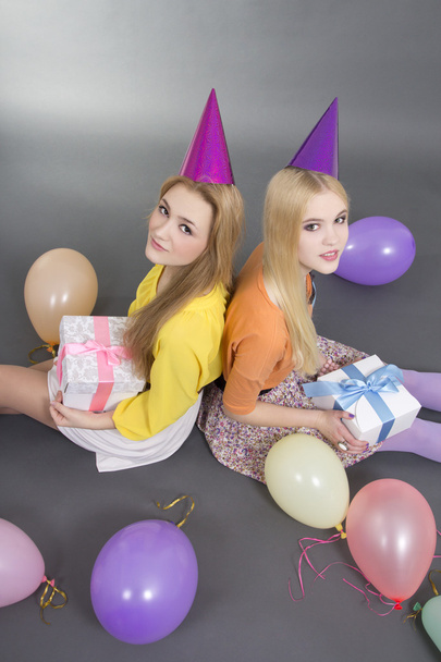 smiling teenage girls with gifts and colorful balloons - Photo, Image