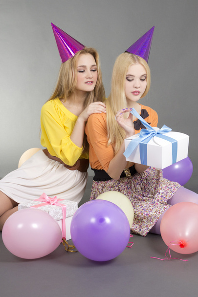 girls sitting with gifts and colorful balloons - Photo, Image