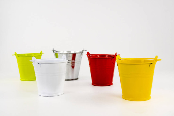 Multicolored small buckets  on a white background. table decorating item. - Photo, Image