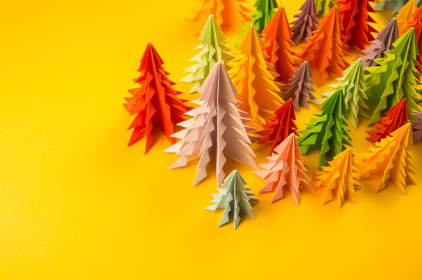 Multicolored paper Christmas tree on a yellow background. Christmas holiday. Children's holiday. - Photo, Image