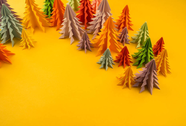 Multicolored paper Christmas tree on a yellow background. Christmas holiday. Children's holiday. - Fotoğraf, Görsel