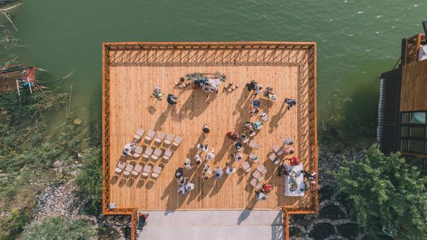 Complex Olympic Village. August 4, 2018. Kiev (Kyiv). Ukraine. Aerial view of the wedding ceremony. People. Bride and groom. Lake. - Foto, Imagem