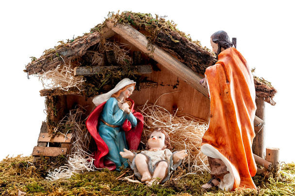 Christmas nativity scene. Hut with baby Jesus in the manger, with Mary and Joseph. Isolated on white background. - Photo, Image