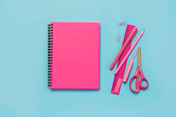 Pink girlish school supplies, notebooks and pens on punchy blue background. Top view, flat lay. Copy space. - Valokuva, kuva