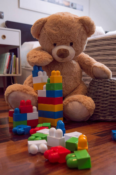 Kids toys background with teddy bear and colorful bricks. - Foto, immagini
