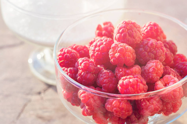Glass of fresh raspberries and white sugar gardening gastronomy harvest - 写真・画像