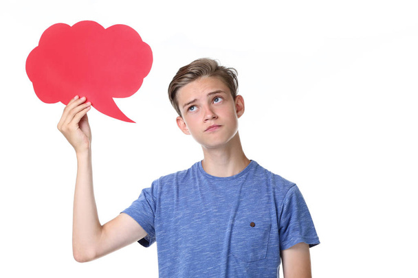 Cute teenager holding speech bubble on white background - 写真・画像