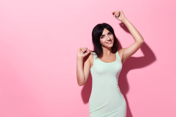 Young woman in white dress on pink background - Photo, Image