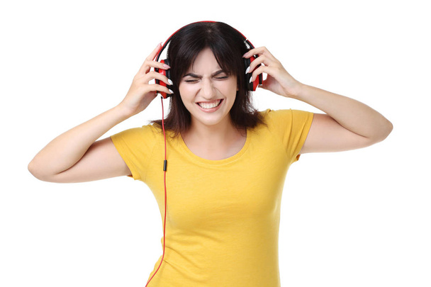 Young woman with headphones on white background - Foto, immagini