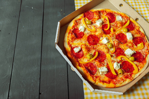Fresh tasty pizza on wooden background - Фото, зображення