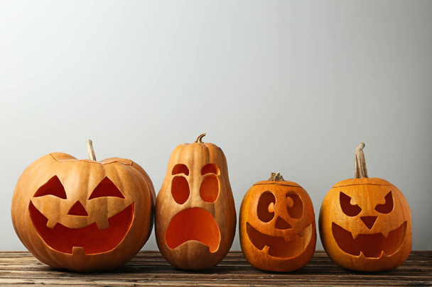 Halloween pumpkins on brown wooden table - Valokuva, kuva