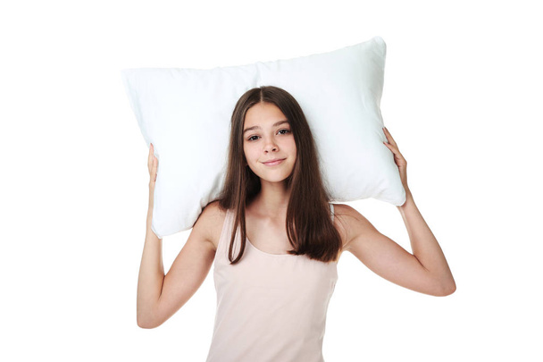 Young girl holding pillow on white background - Foto, Imagem