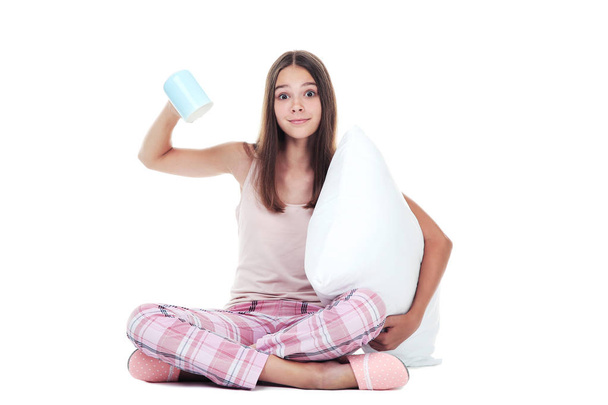 Young girl holding pillow and cup on white background - Foto, immagini