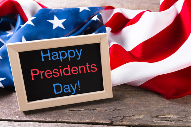 the text happy presidents day written in a chalkboard and a flag of the United States - Фото, изображение