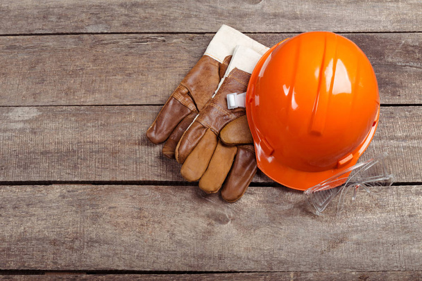 hardhat and old leather gloves - 写真・画像