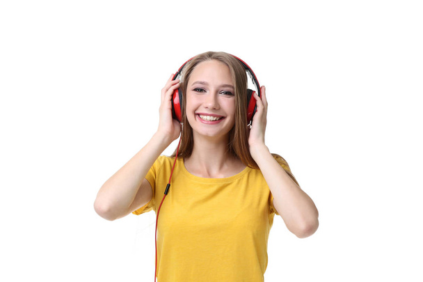 Young woman with headphones on white background - Фото, зображення