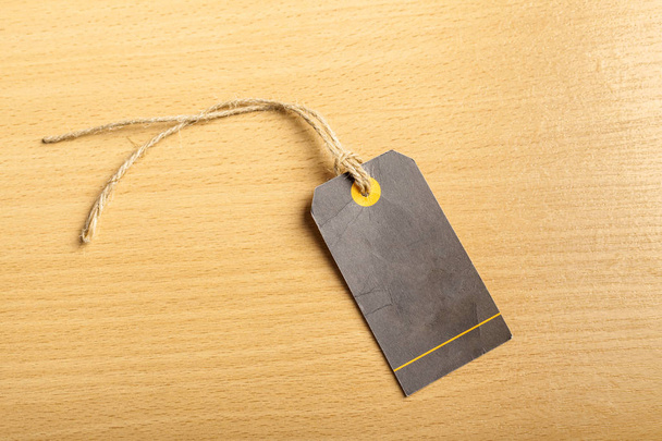 Blank tag with craft string on wooden background - Fotó, kép