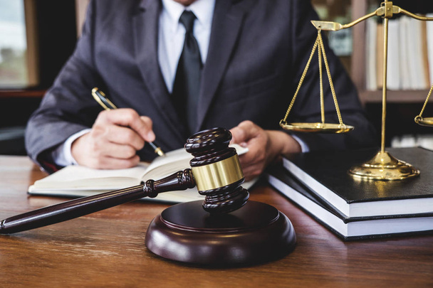 Legal law, advice and justice concept, Judge gavel with Justice lawyers, Counselor in suit or lawyer working on a documents in courtroom. - Photo, image