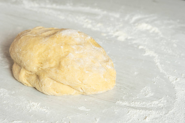 Dough for traditional challah jewish bread on light wooden background - Фото, изображение