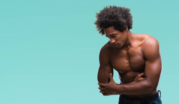 Afro american shirtless man showing nude body over isolated background with hand on stomach because nausea, painful disease feeling unwell. Ache concept. - Valokuva, kuva