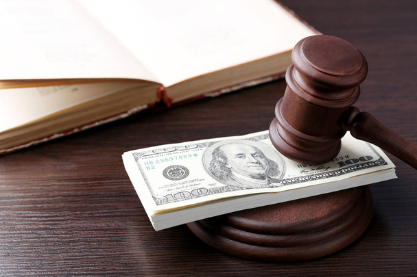 Judge gavel with dollars and book on wooden table - Foto, Bild