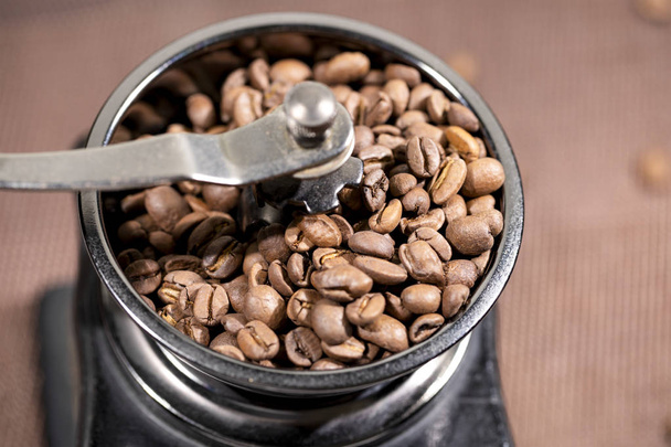 The fried coffee beans lie in a coffee grinder. Arab coffee is prayed in a mechanical coffee grinder. Morning coffee. - Photo, image