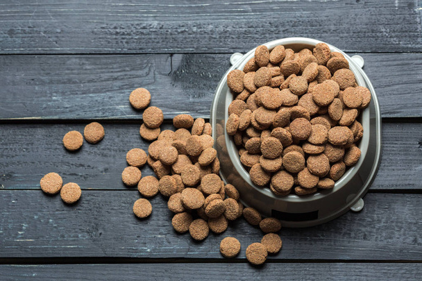 pets food in bowl on wooden floor - Photo, image