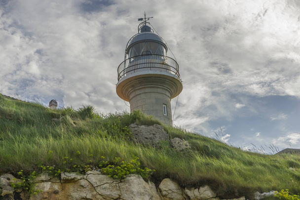 Summer, coastal lighthouse on the Playa de los Locos in Cantabria, Spain - Fotó, kép
