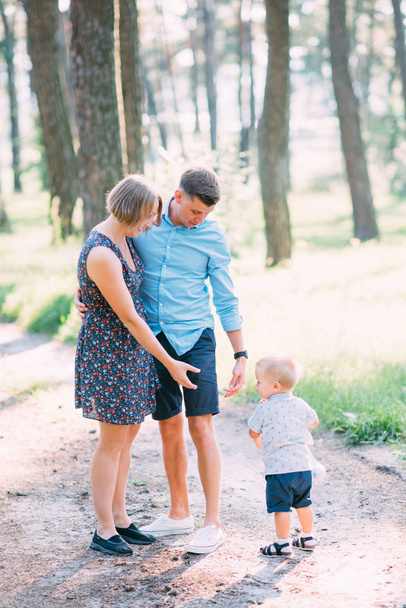 A cute family - mom, dad and son spend fun time in nature. - 写真・画像