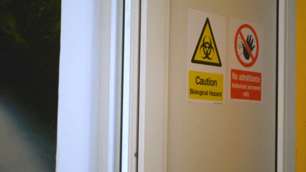Man enters dangerous secret biological laboratory, door closes behind him - Footage, Video