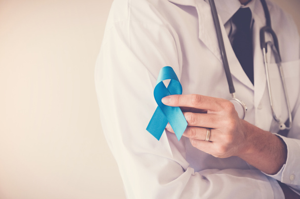 Doctor hands holding Light blue ribbon,  Prostate Cancer Awareness - 写真・画像