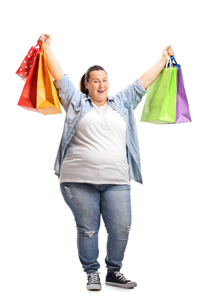 Full length portrait of an overjoyed woman with shopping bags isolated on white background - Foto, immagini