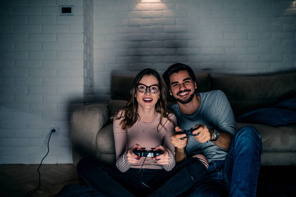 Young couple having fun playing video games - Foto, Imagen