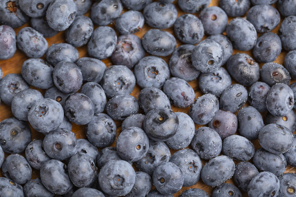 Blueberry on wooden table background. Ripe fresh  blueberries closeup. Berries closeup - Foto, imagen