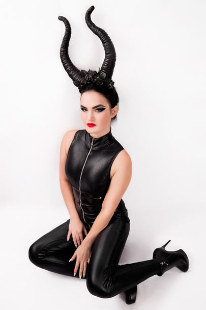 photo of girl in a witch costume with horns - Photo, Image