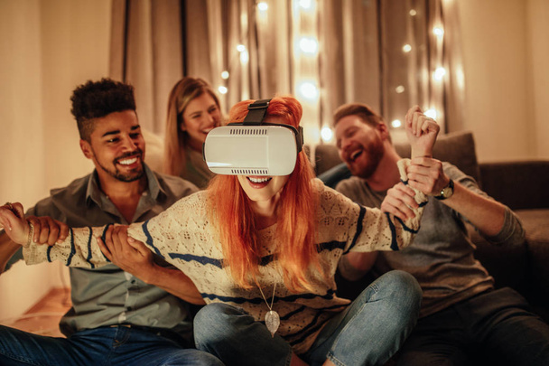 Group of friends having fun with virtual reality - 写真・画像